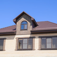 The house with plastic windows and a roof of corrugated sheet