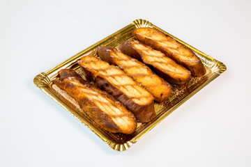 pastries in a gold tray on white background