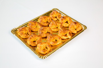 croissant in a gold tray on white background