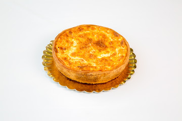 quiche on a gold tray with white background