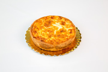 quiche on a gold tray with white background