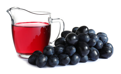 Jug with wine vinegar and fresh grapes on white background