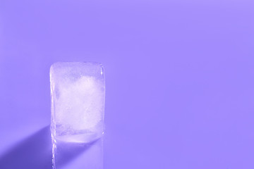 Ice cube on color background. Space for text