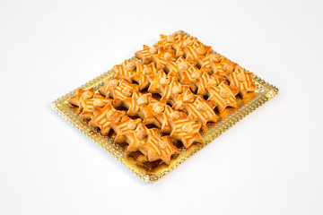 star cookies on a gold tray with white background