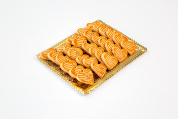 heart cookies on a gold tray with white background