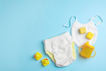 Flat lay composition with baby accessories on color background. Space for text