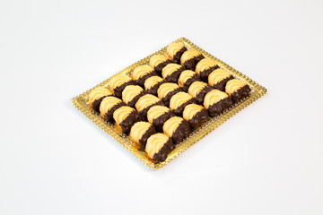 cookies on a gold tray with white background