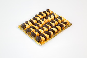 cookies on a gold tray with white background