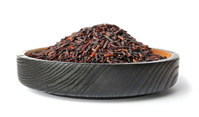 Plate with uncooked black rice on white background