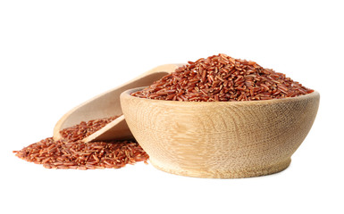 Bowl and scoop with uncooked brown rice on white background