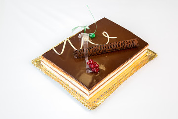 chocolate cake on a gold tray on white background