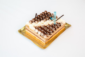 cake on a gold tray on white background