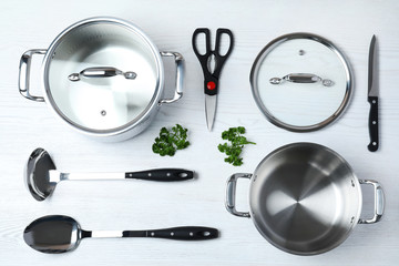 Flat lay composition with clean cookware on white wooden background