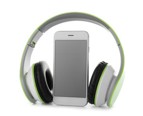 Smartphone with blank screen and headphones on white background