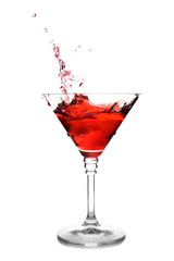 Glass of martini cocktail with splash on white background