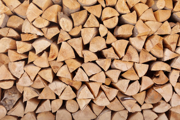 Stacked firewood as background. Heating house in winter