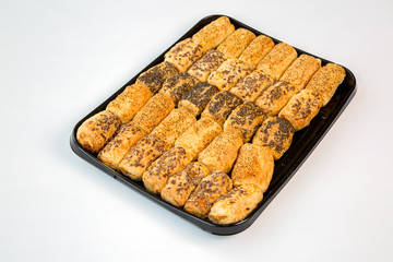 salted snacks on a black tray with white background