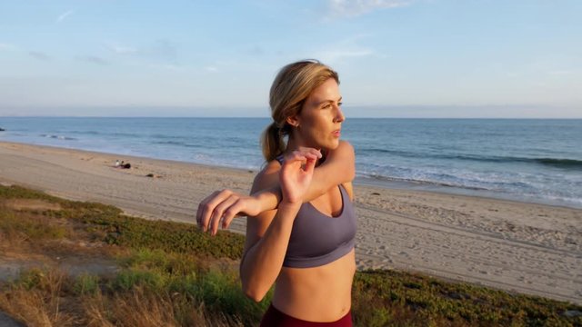 Attractive blond woman working out at the beach.