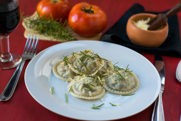 Making homemade pasta: Large round ravioli (Sorrentino) cooked, served on a dish, ready to eat