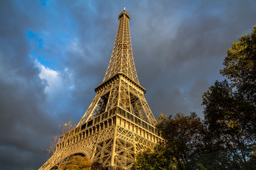 View on Eiffel tower, dark clouds and sunshine, Paris