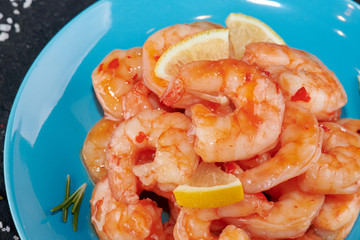 Shrimp cocktail background with close - up view of a group of fresh delicious chilled crustaceans as exquisite seafood for a party or dinner at a restaurant serving dishes from the sea.
