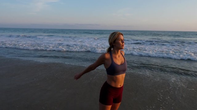 Attractive blond woman working out at the beach.