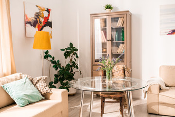 Warm toned background image of cozy living room interior lit by sunlight, copy space