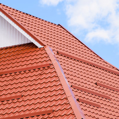 Fototapeta premium The roof of corrugated sheet red orange