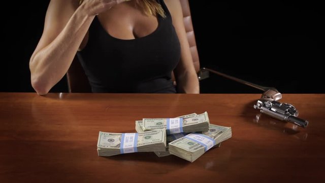 Dangerous and sexy woman with a pile of money.
