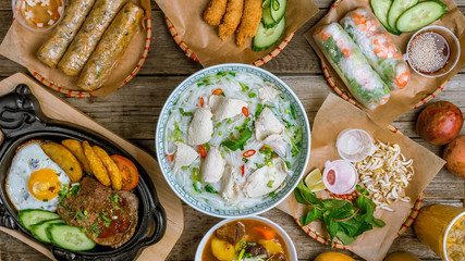 Assorted asian dinner, vietnamese food. Pho ga, pho bo, noodles, spring rolls - obrazy, fototapety, plakaty