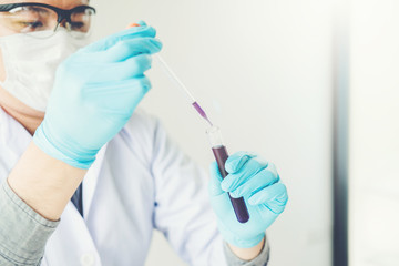 Scientist with equipment holding tools during scientific experiment science concept