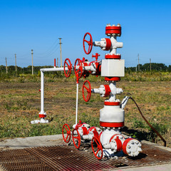 Fototapeta na wymiar Well for oil and gas production. Oil well wellhead equipment. Oi