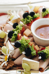 Set of skewer canapes and sauce on plate 