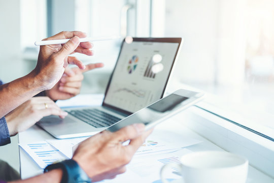 Co-working Business Team meeting Planning Strategy Analysis investment and saving concept. meeting discussing new plan financial graph data on Laptop.
