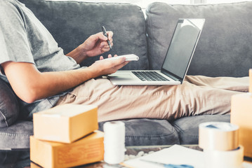 SME freelance man working with packaging startup entrepreneur small business owner at home,Online business seller packaging and delivery concept