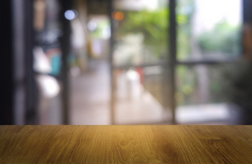 Empty dark wooden table in front of abstract blurred background of restaurant, cafe and coffee shop interior. can be used for display or montage your products - Image.