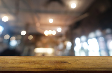 Empty dark wooden table in front of abstract blurred background of restaurant, cafe and coffee shop interior. can be used for display or montage your products - Image.