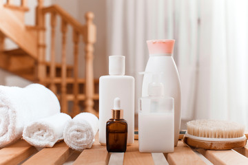 Obraz na płótnie Canvas two bottles of shampoo and towel on white background