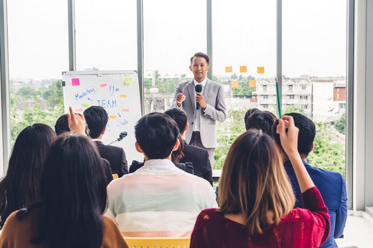 Businessman standing in front of group of people in consulting meeting conference seminar at hall or seminar room.presentation and coaching concept