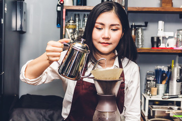 Women Barista making drip coffee in the cafe