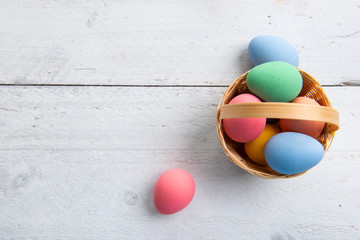 Colored easter eggs on white wooden