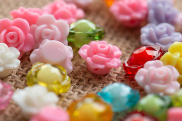 Colorful flower plastic beads on wooden