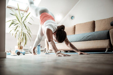 Attentive woman staying in professional yoga posture