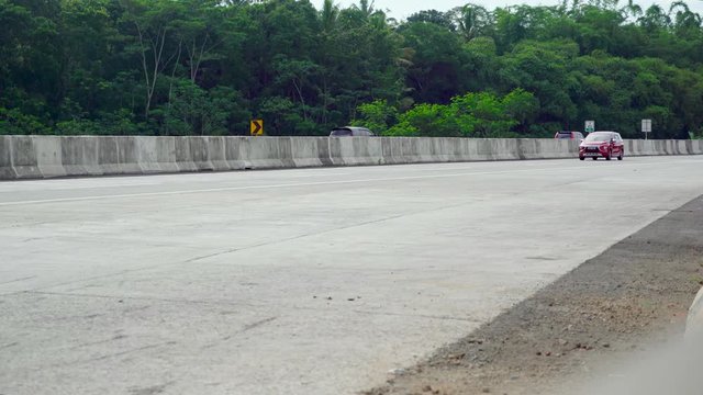 SEMARANG, Indonesia - January 17, 2019: Fast traffic on the Trans-Java Toll Road from Semarang to Salatiga in Central Java, Indonesia. Shot in 4k resolution