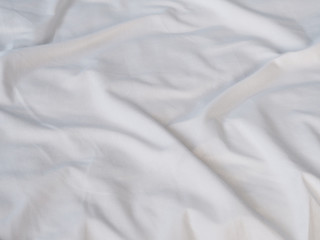 crumpled white bedsheet surface