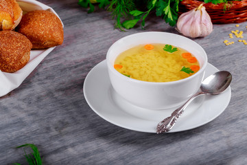 Chicken broth and ingredients on the table close-up. horizontal, rustic style