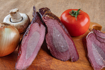 Smoked meats (Dried meat ) on wooden background.