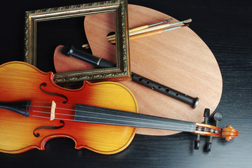 Attributes of art. Violin, flute, art palette, brushes,