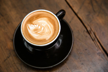 Cup of coffee on wooden table