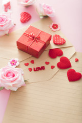 Valentine Day gift box with red hearts and roses on letter envelope